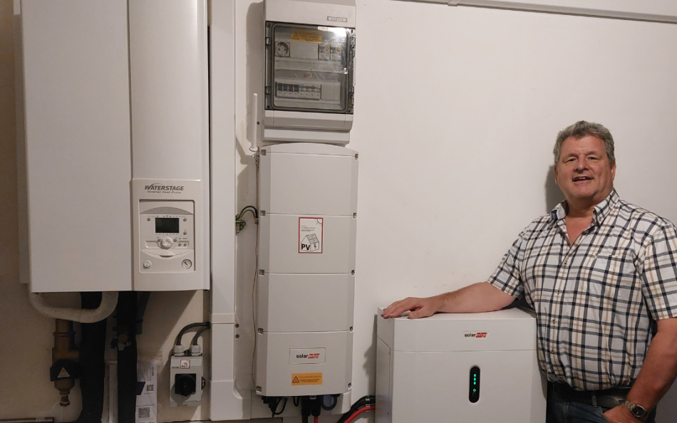 Pieter bij zijn warmtepomp, omvormer en e-accu.
